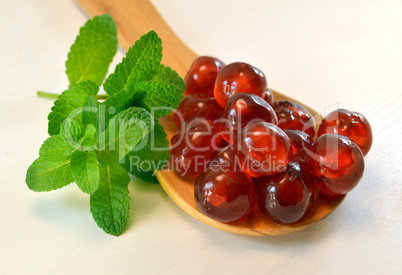 Candied cherries with mint leaves