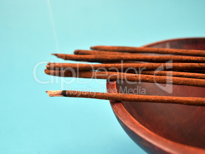 Incense sticks on blue background