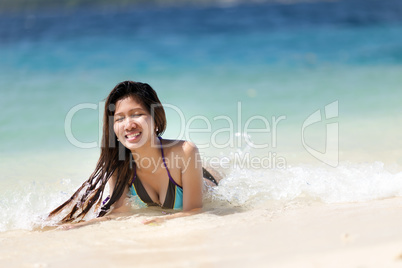young filipina woman swimming in the sea
