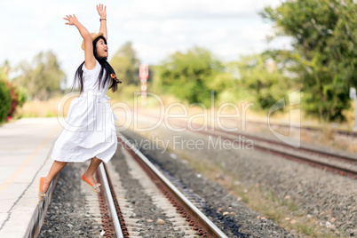 young girl leaping off a train station platform