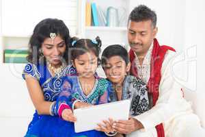 indian family using tablet pc computer at home