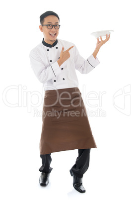 asian male chef pointing an empty plate