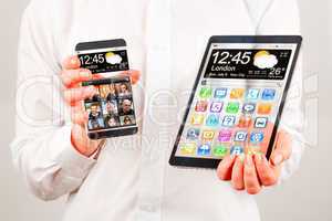 smartphone and tablet with transparent screen in human hands.