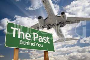 The Past Green Road Sign and Airplane Above