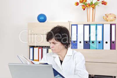 family doctor in the meeting room reads the book