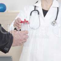 doctor passes urine cups to patients