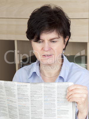woman in middle age reading newspaper
