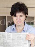 woman in middle age reading newspaper