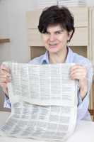 woman in middle age reading newspaper