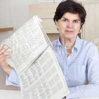 woman in middle age reading newspaper