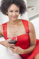 mixed race african american girl drinking red wine