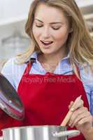 woman cooking kitchen with red apron
