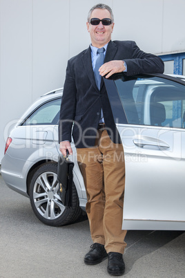 businessman standing on the car