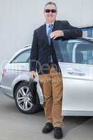 businessman standing on the car