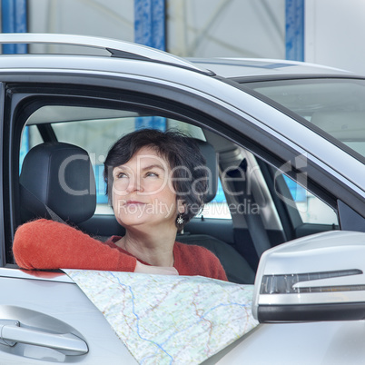 woman with car and map asks for the way