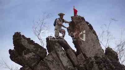 Male Climber with Red Flag