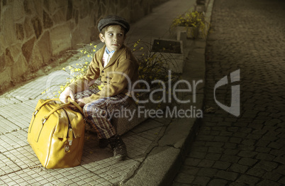 Child on a road with vintage bag