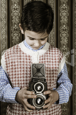 Child taking pictures with vintage camera