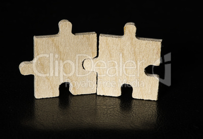 Wooden puzzle on black background