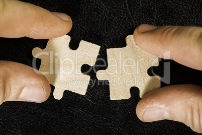 Wooden puzzle on black background. Close up