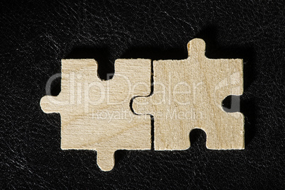 Wooden puzzle on black background