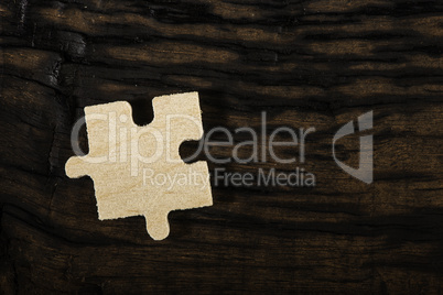 Wooden puzzle on dark background.