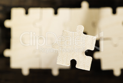 Wooden puzzle on dark background.