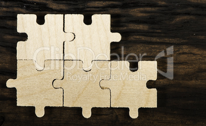Wooden puzzle on dark background.