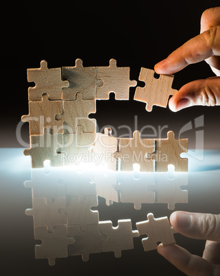 Wooden puzzle and backlight background. Close up