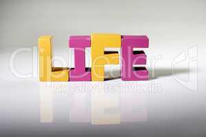 Multicolored word life made of wood.