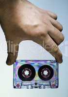 Hand holding vintage cassette tape