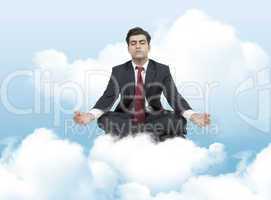 business man meditates on clouds