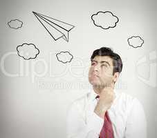 man thinking of flying on a paper plane