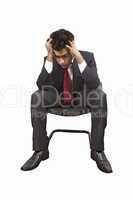 man sitting on a chair pulling his hair off