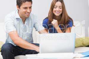 Cute couple using laptop at home