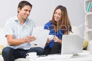 Couple paying their bills online at home