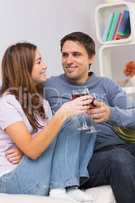 Smiling couple toasting wine glasses at home Smiling couple toasting wine glasses at home