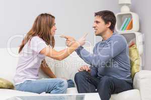 Angry couple having an argument in their living room