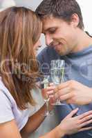 Close-up of a romantic couple with flutes at home
