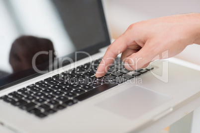 Han's hand using laptop keyboard