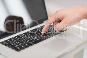 Han's hand using laptop keyboard