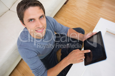 Overhead portrait of man using digital tablet in living room