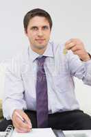 Businessman with documents holding up keys