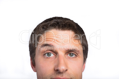 Close-up of a green eyed man raising eyebrow