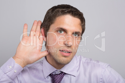 Close-up of a green eyed businessman with hand to ear