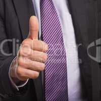 Businessman in suit gesturing thumbs up