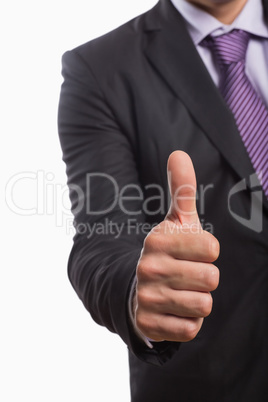 Mid section of a businessman gesturing thumbs up