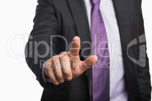 Businessman pointing against white background