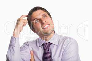 Close-up of a thoughtful businessman looking up