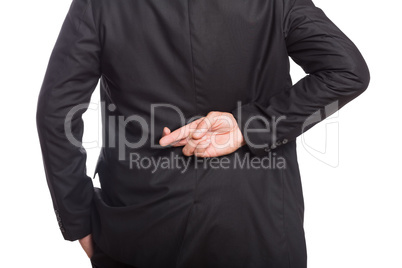 Mid section of a businessman with crossed fingers